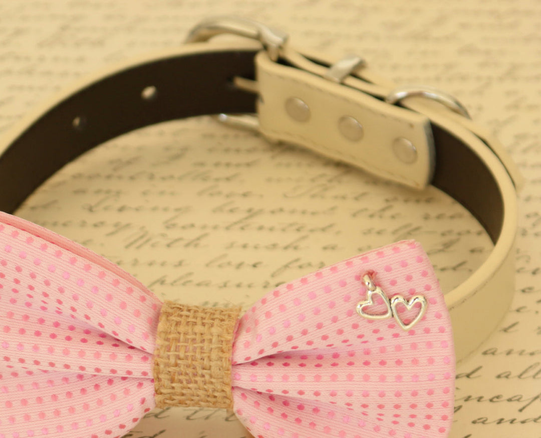 Close-up of pink burlap dog bow tie with silver double heart charm attached to a cream vegan leather collar.