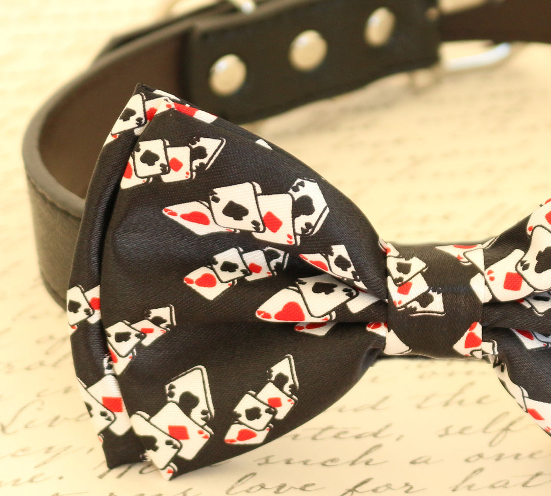 Close-up of a black dog bow tie featuring a playing card pattern attached to a brown vegan leather collar