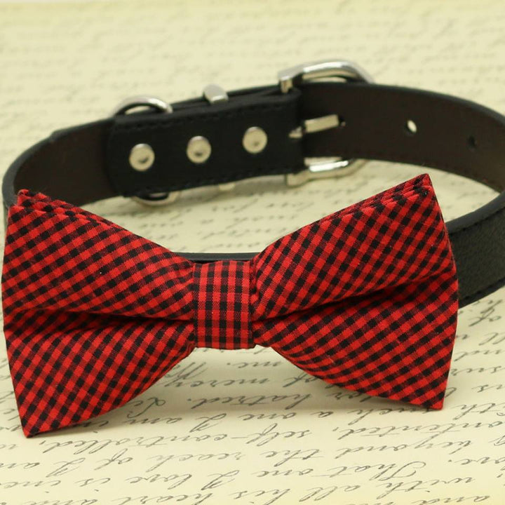 Red and black gingham check dog bow tie attached to a black vegan leather dog collar.