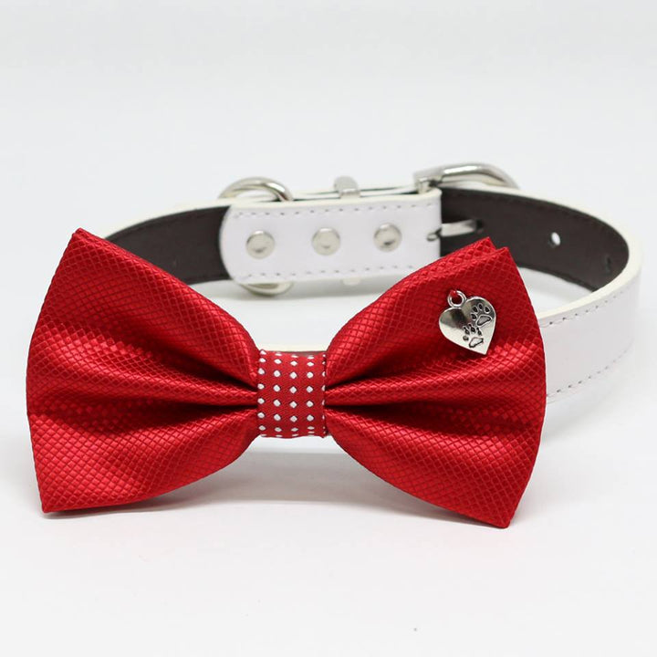 Red metallic dog bow tie collar with paw print heart charm and white vegan leather collar.