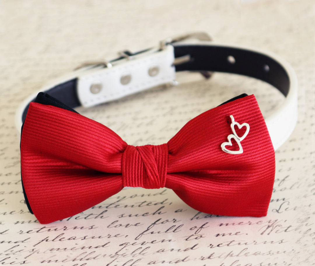 Red ribbed dog bow tie collar with silver double heart charm and white vegan leather collar.