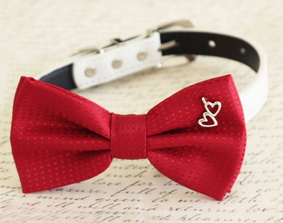 Red satin dog bow tie collar with silver double heart charm and white vegan leather collar.