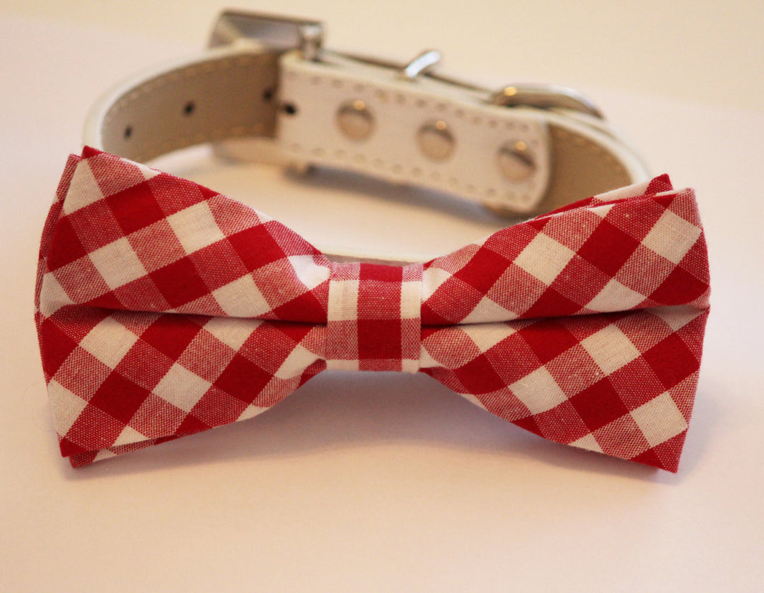 Red and white gingham check dog bow tie attached to a white vegan leather dog collar.
