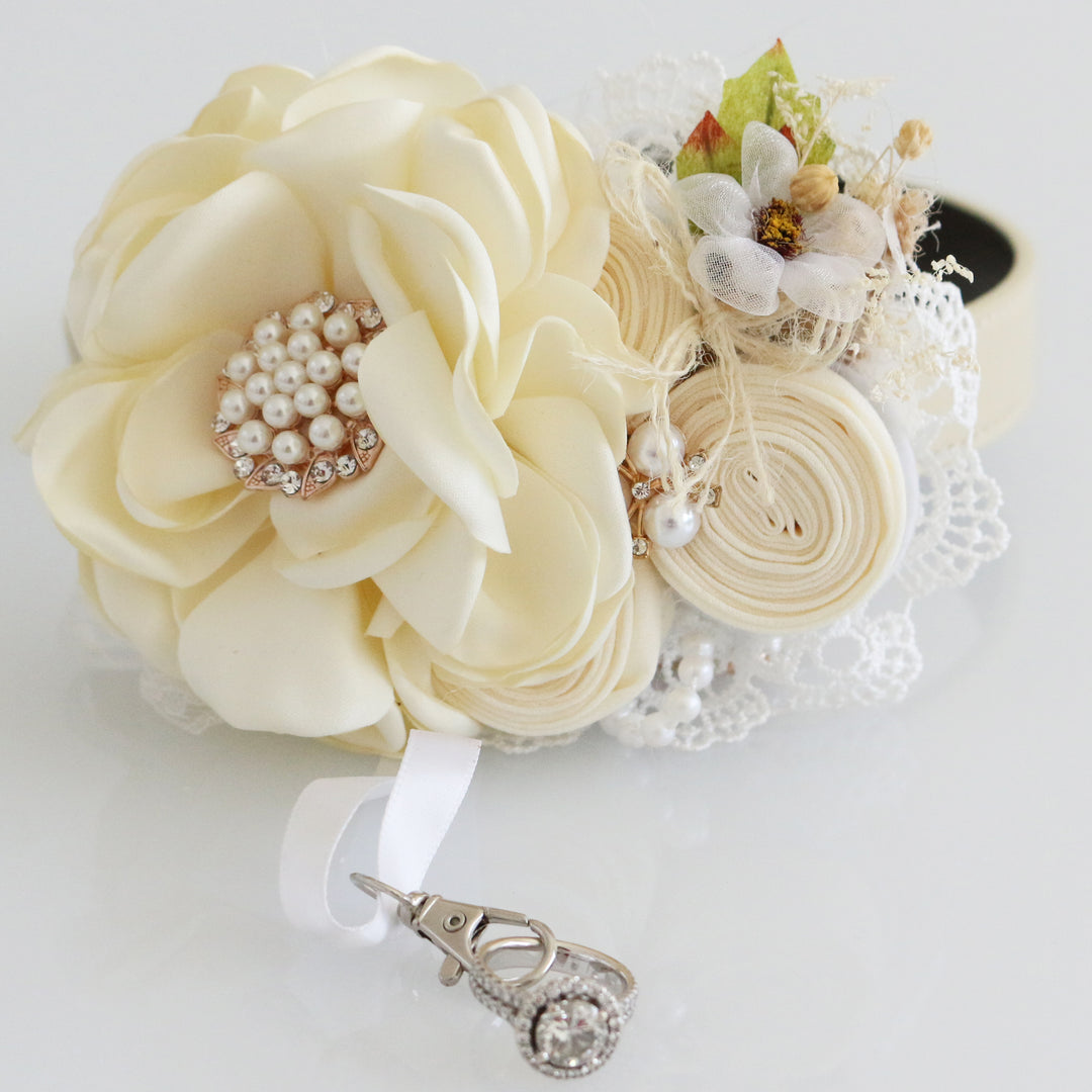 Rustic ivory wedding dog collar featuring fabric flowers, rolled rosettes, pearl accents, dried botanical detail, and removable ring holder ribbon.