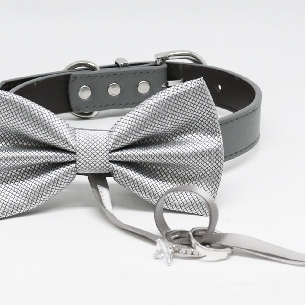 Close-up of a silver textured ring bearer dog bow tie collar with wedding ring holder ribbon and black vegan leather collar.