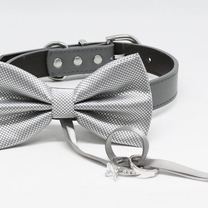 Close-up of a silver textured ring bearer dog bow tie collar with wedding ring holder ribbon and black vegan leather collar.