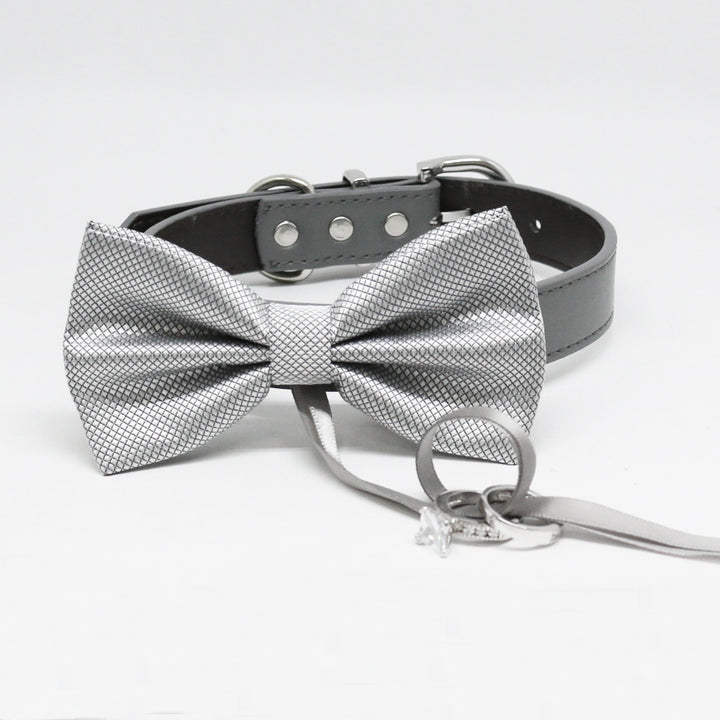 Silver textured ring bearer dog bow tie attached to a black vegan leather collar with wedding ring holder ribbon.