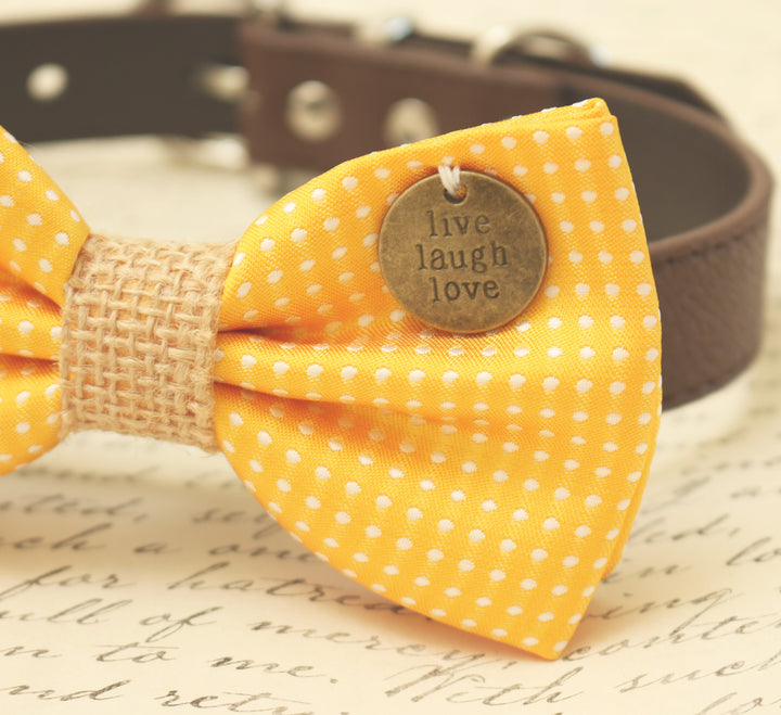 Close-up of a yellow polka dot dog bow tie with burlap center and live laugh love charm.